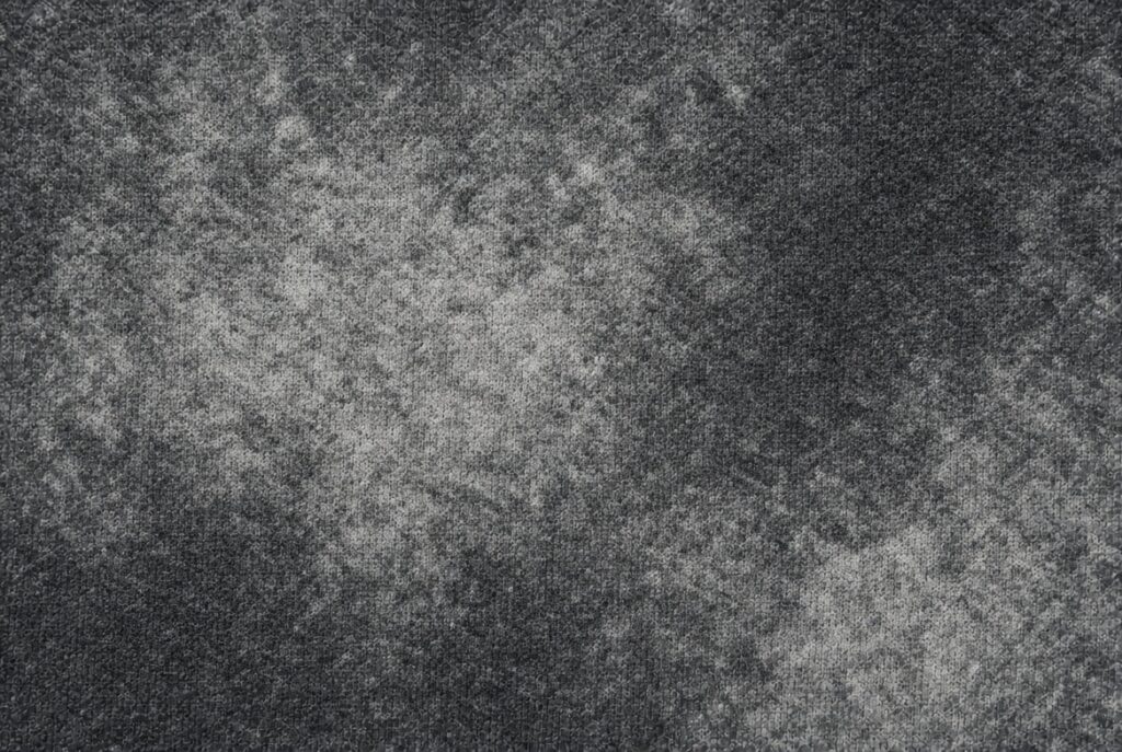 close-up of acid wash hoodie fleece with irregular bleach contrast.